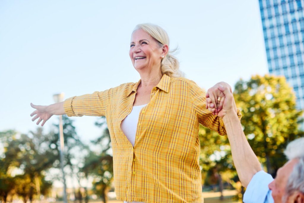 Happy elderly woman enjoying outdoors