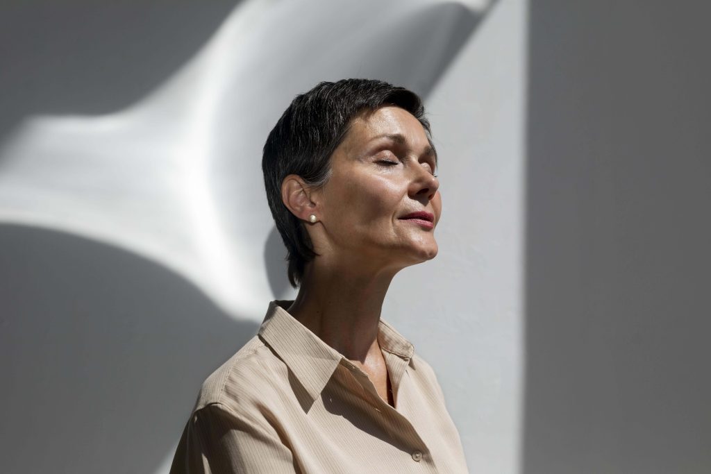 Serene woman enjoying soft light.