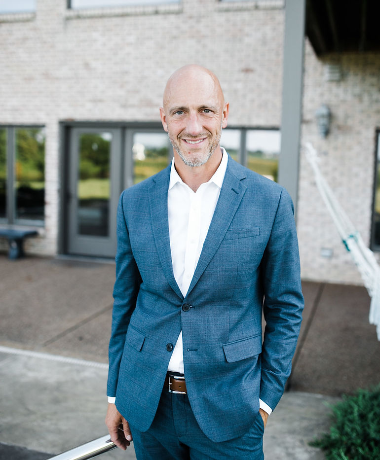 Man in suit smiling outdoors