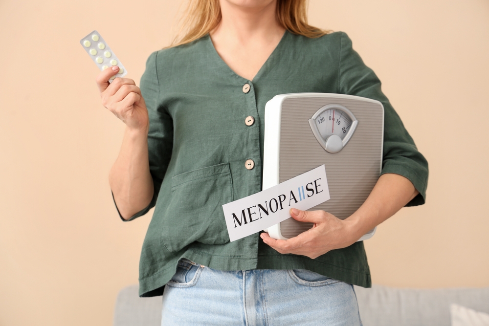 Woman holding scale and medication