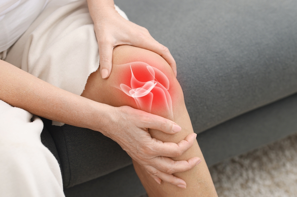 Person holding knee in pain