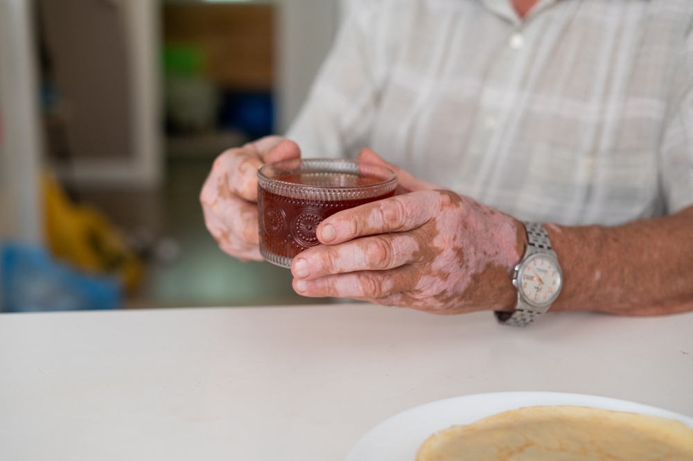 Person holding a glass of beverage