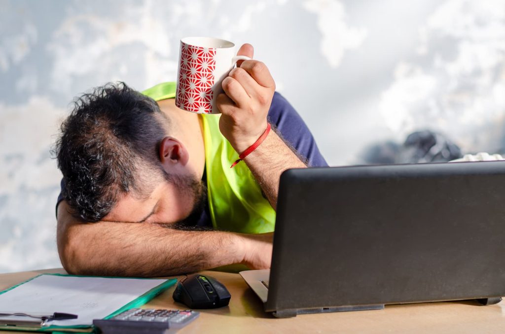 Tired person resting on desk