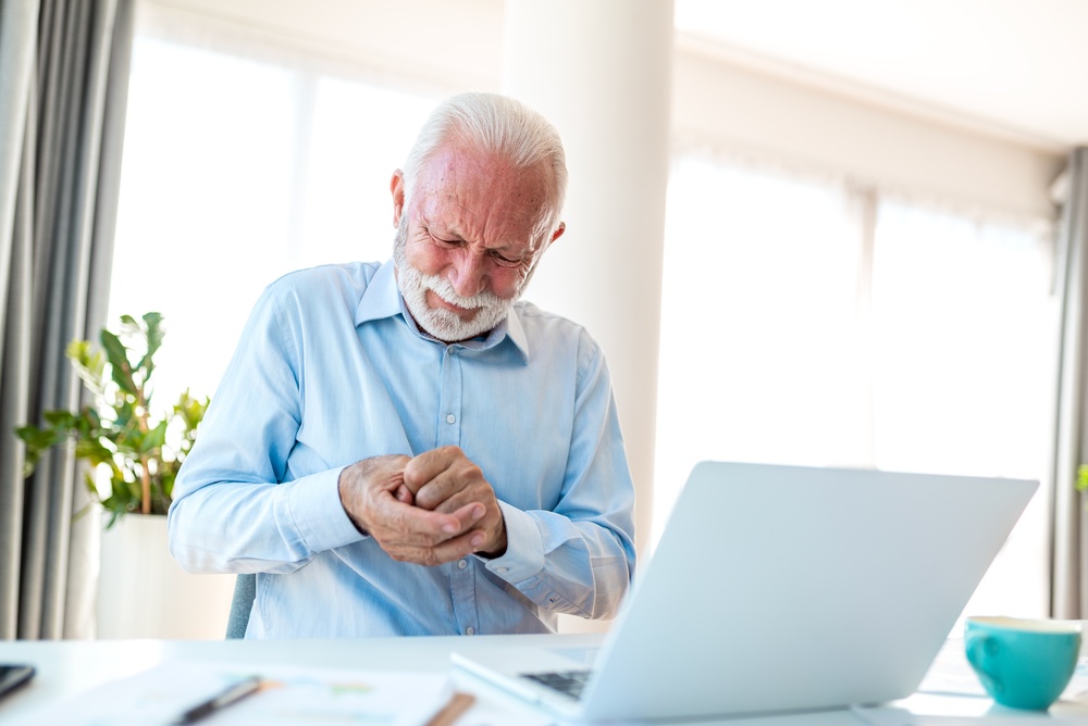 Elderly man experiencing wrist pain