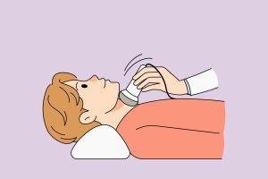 Woman checking her neck for thyroid symptoms